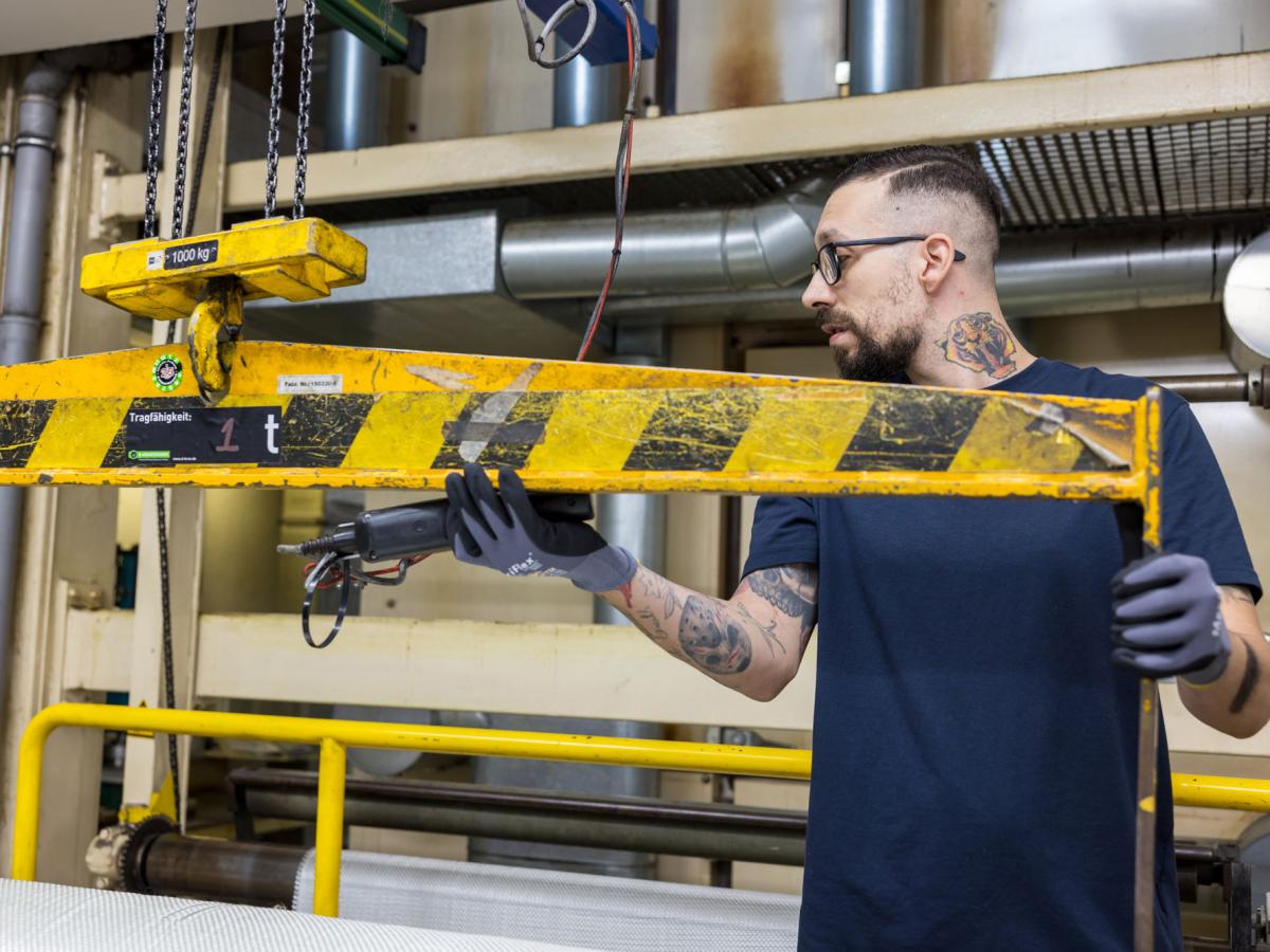 Man working on a machine looking at the side of the image